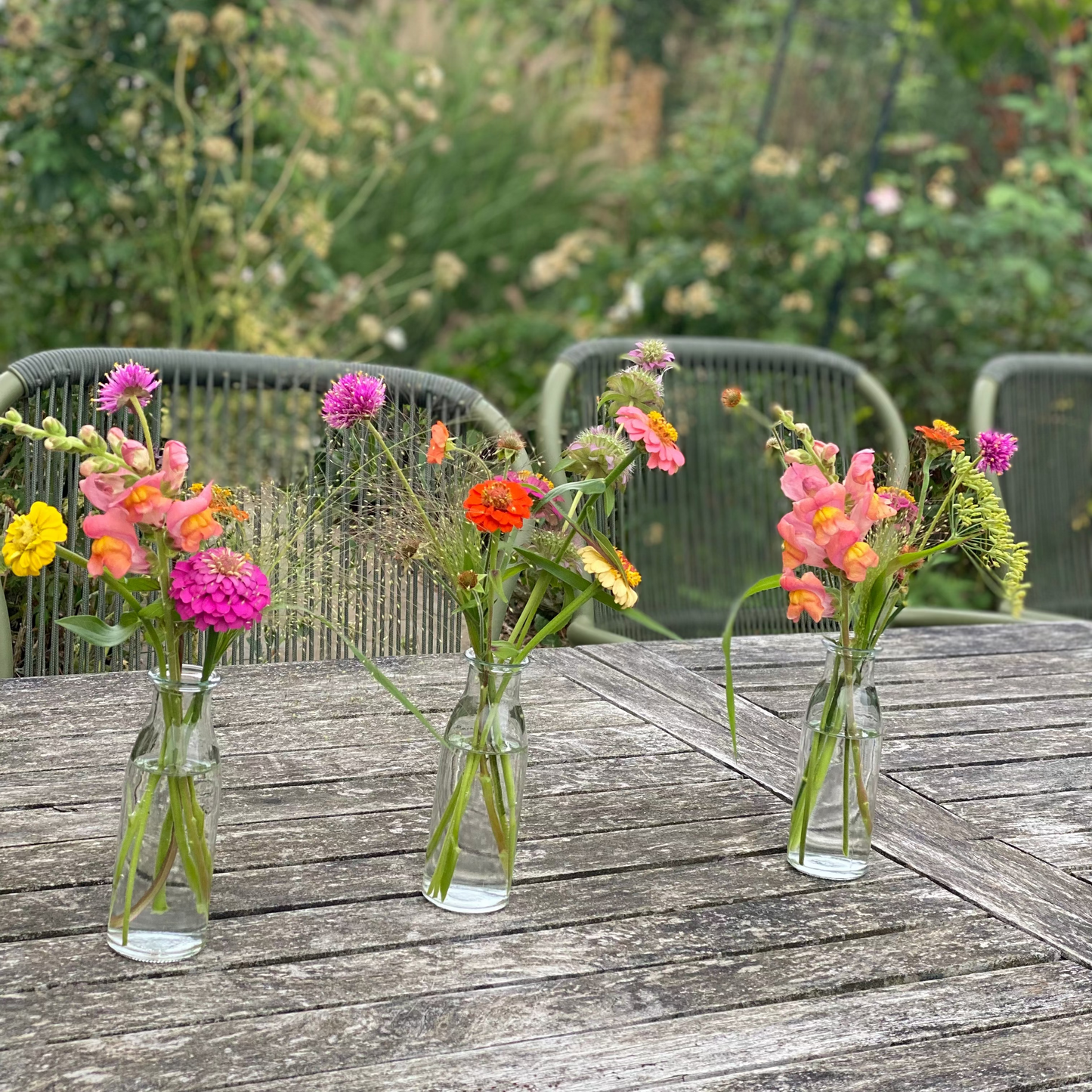 Filled table vases with seasonal flowers