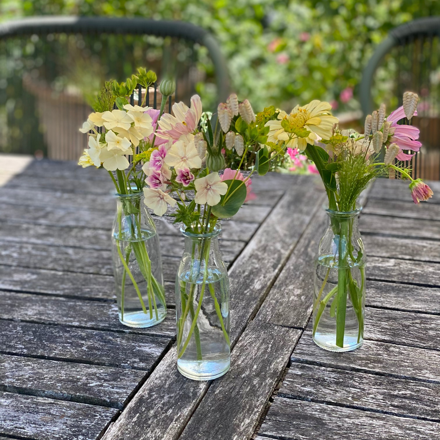 Filled table vases with seasonal flowers