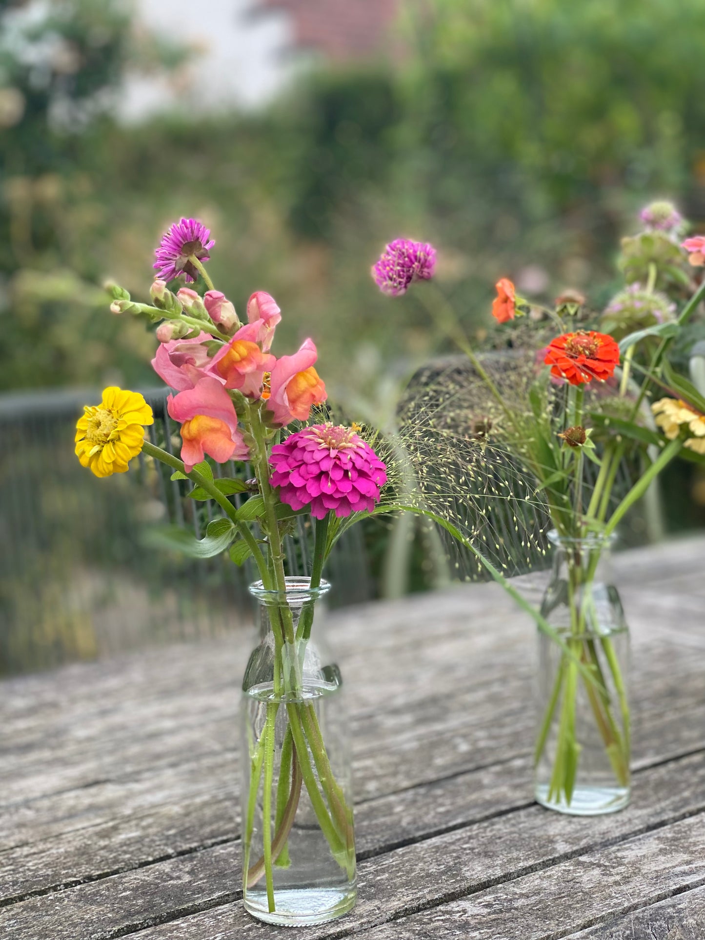 Filled small table vases with fresh flowers
