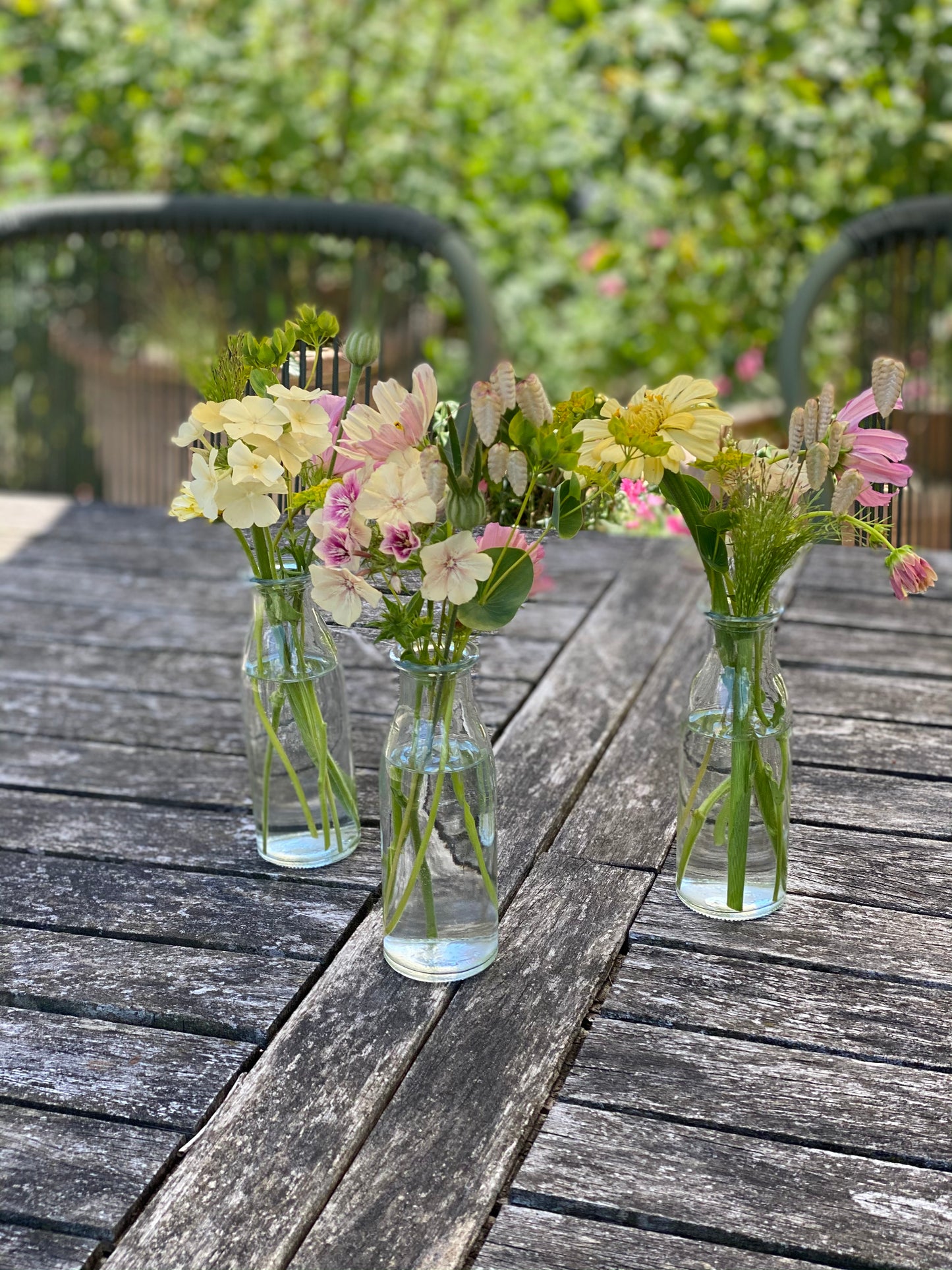 Filled small table vases with fresh flowers